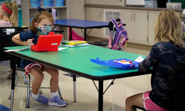students talk across table